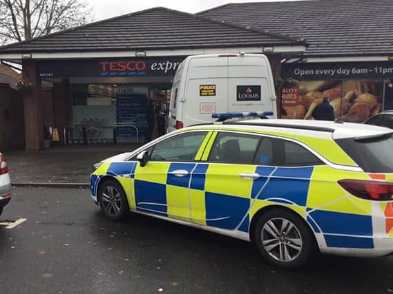A security van has been blocked in by a police car. Photo: Ciaran O'Meara