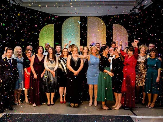 Winners of this years Leamington Business Awards gather on stage for a
confetti cannon finale at the Royal Pump Rooms