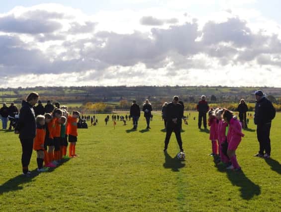 Rugby Town Girls Under 10s, their opponents and supporters observing the minute's silence