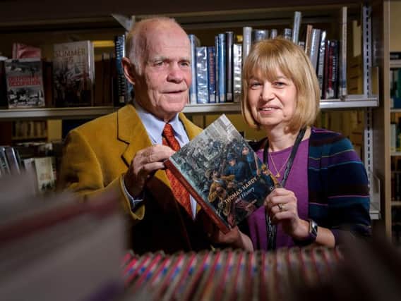 Dr Fred Reid (left) presenting his book 'Thomas Hardy and History' to librarian Linda Young